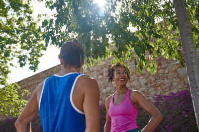 Cheerful sporty couple standing together outdoors