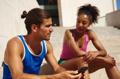 Couple sitting together on a staircase outdoors