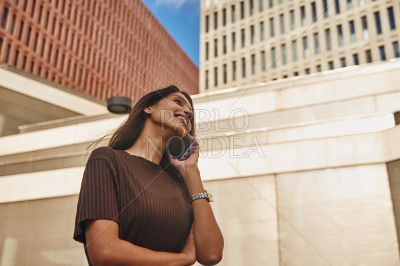 Smiling businesswoman talking by mobile phone