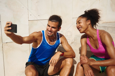 Smiling couple taking a selfie together outdoors