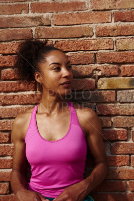 Sporty young woman looking away thoughtfully