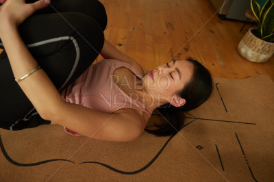 Woman relaxing while stretching during yoga