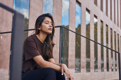 Young businesswoman sitting with closed eyes