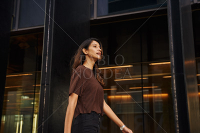 Young businesswoman walking on street smiling