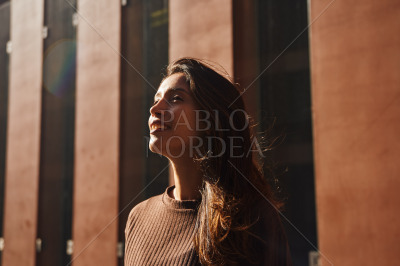Young happy businesswoman standing on street