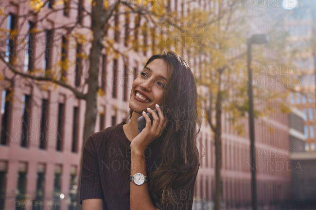 Beautiful woman smiling while talking on phone