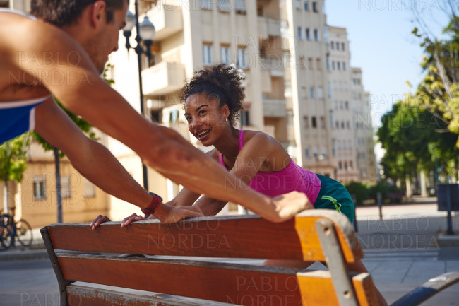 Happy young couple exercising outdoors in the city