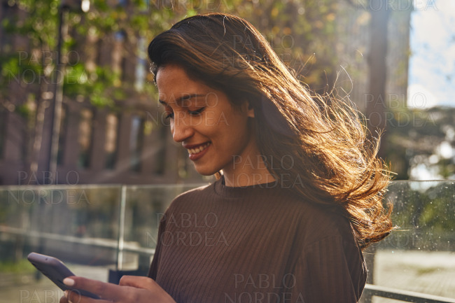 Portrait of young businesswoman holding phone