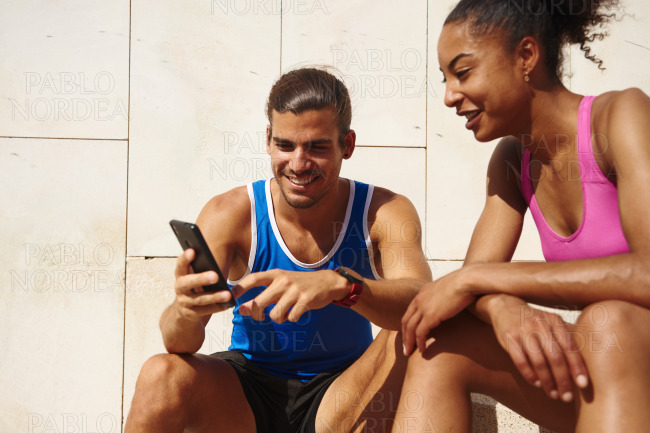Smiling couple surfing the net on a smartphone