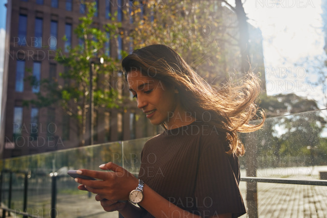 Smiling happy businesswoman with mobile phone