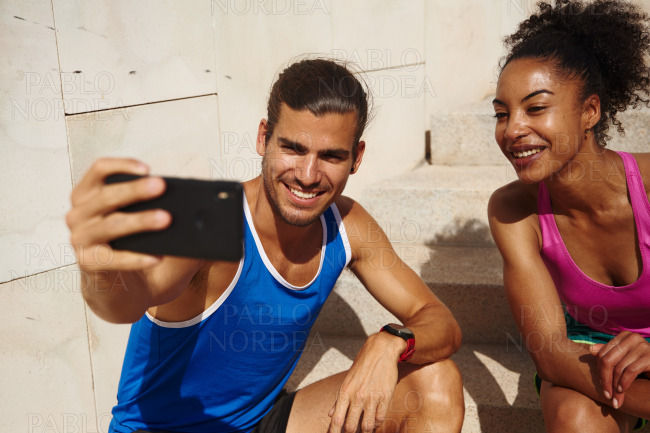 Sporty couple taking a selfie together outdoors