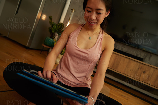 Woman sitting and using tablet while yoga