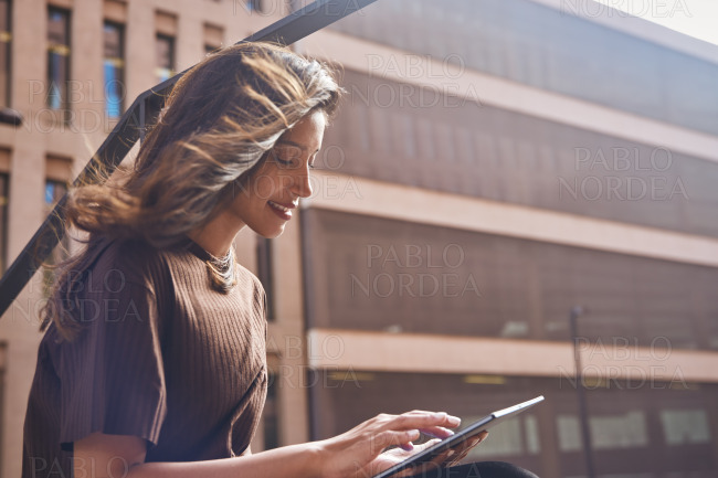 Young beautiful businesswoman sitting with tablet
