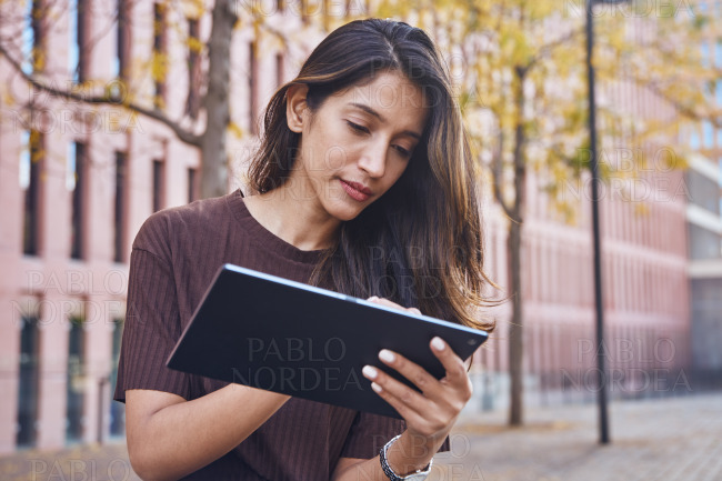 Young beautiful businesswoman standing with tablet