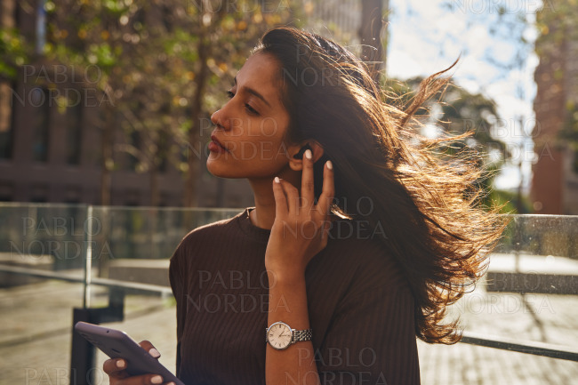 Young beautiful businesswoman using mobile phone