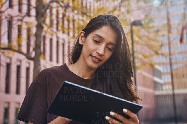 Young beautiful businesswoman working on tablet