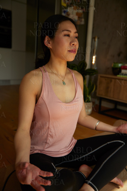 Young beautiful woman practicing yoga in the room
