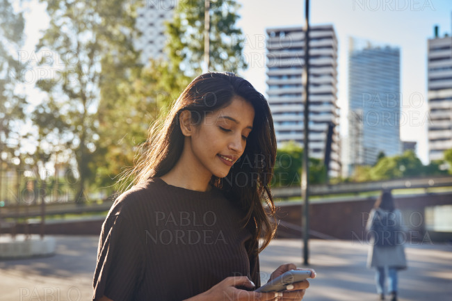 Young businesswoman text messaging on street