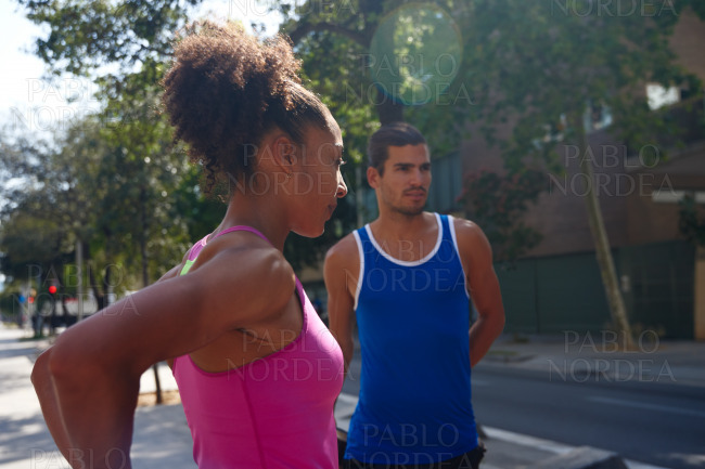 Young ethnic couple working out together outdoors