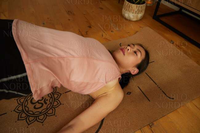 Young fit woman practicing yoga on mat