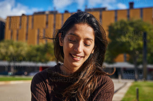 Young relaxed businesswoman sitting in park