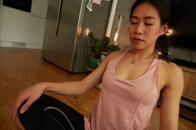 Young woman sitting and stretching during yoga