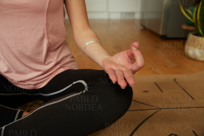 Young woman sitting in yoga pose in balance