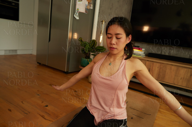 Young woman with closed eyes practicing yoga