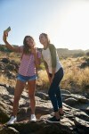 Girls on a rock taking selfies