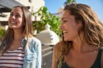 Two young girls laughing and joking