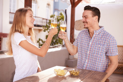 Couple raising and clinking their glasses