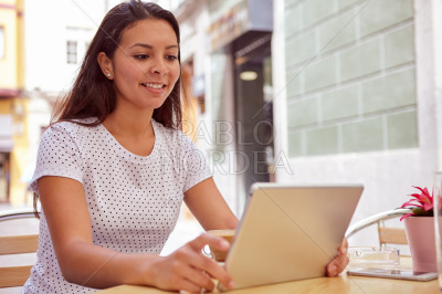 Girl with tablet in a coffee shop