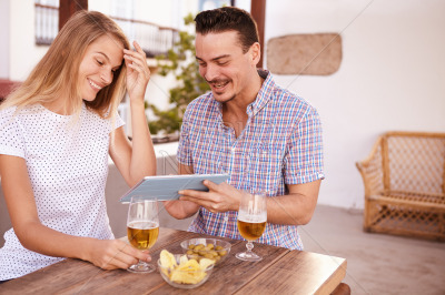 Goodlooking young couple looking at tablet