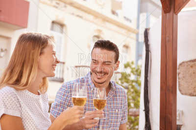 Happily laughing couple drinking some beers