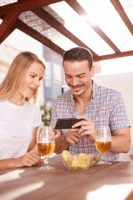 Happy couple looking at a cellphone
