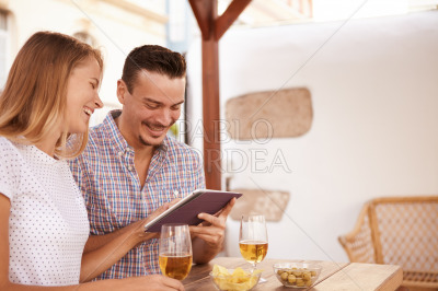 Happy young couple using a touchpad