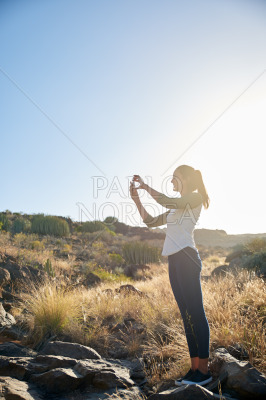 Lovely young woman taking a photo