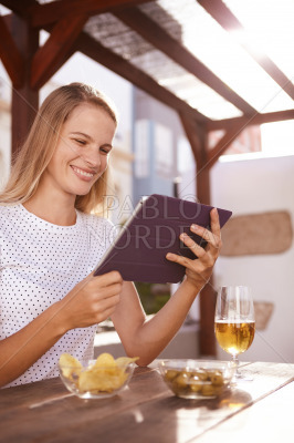 Pretty blond looking at her tablet