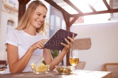 Pretty blond pointing at her tablet