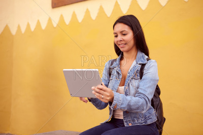 Pretty girl sitting with a tablet pc