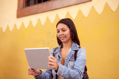Pretty young girl reading on tablet pc