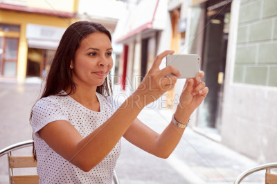 Secretive smiling young girl taking pictures