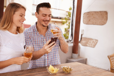 Smiling couple looking at his cellphone