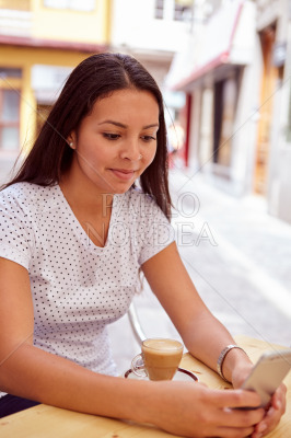 Smiling girl sitting in coffee shop