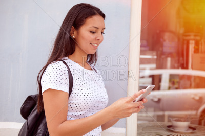 Young girl smiling at her cellphone