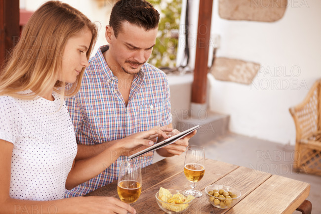 Concentrating couple with touchpad and beers