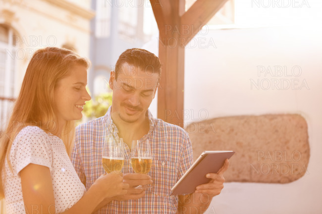 Dating couple with tablet and beers