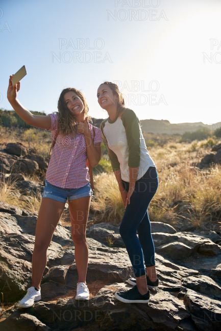 Girls on a rock taking selfies
