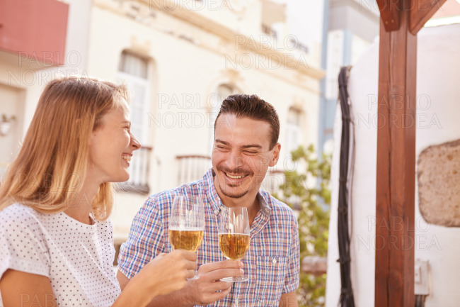 Happily laughing couple drinking some beers