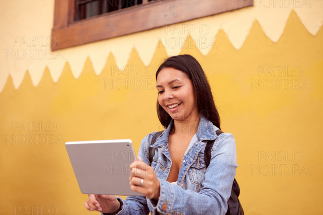 Laughing young girl with a tablet pc